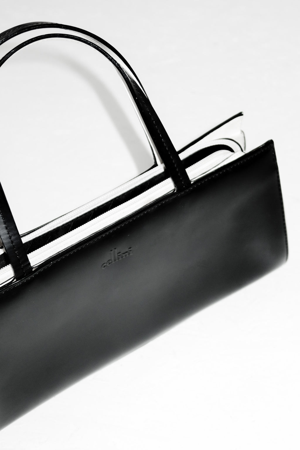 cellini leather top handle bag black/cream.